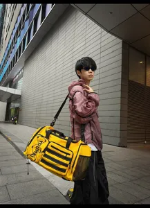 Yellow multi-functional travel gym duffel bag detail showing straps and compartments.