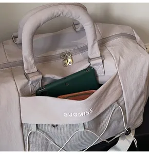 Detailed view of casual travel duffel bag with front mesh pocket and sturdy handles.