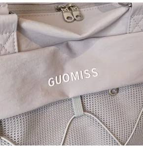 Travel bag detail showcasing durable zippers, mesh pocket, and modern fitness design.