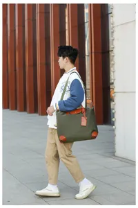 Large capacity nylon travel bag with brown leather trim, lightweight waterproof weekend duffel.