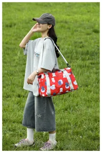 Cute bear print travel duffel bag with shoulder strap for women, stylish weekend luggage.