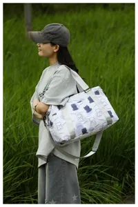 Cute bear print travel duffel bag for women, stylish casual shoulder luggage bag for trips.