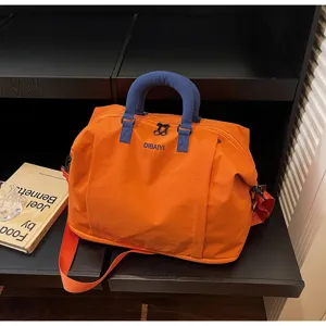 Large capacity orange travel duffel bag with blue handles and shoulder strap for gym and trips.