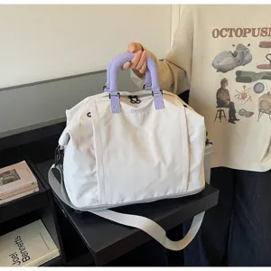 Large capacity travel duffel bag detail view, grey fitness bag with purple handle, durable fabric.