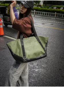 Outdoor travel tote bag detail view, spacious capacity for short trips, urban commute style.