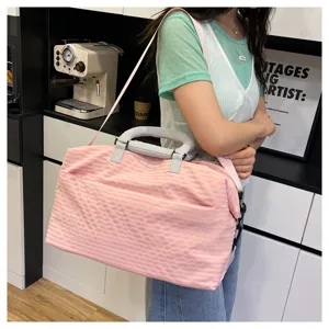 Stylish pink plaid travel duffel bag with shoulder strap for gym, travel and commuting.