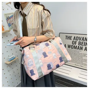 Detailed view of the cute bear print travel duffel bag, showing fabric texture and shoulder strap.