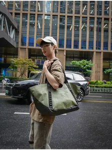 Outdoor travel canvas tote bag detail view, showing large capacity and durable handle design.