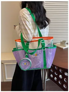 Detail view of the clear mesh tote beach bag with vibrant purple and green straps for summer.