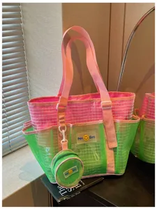 Detailed view of the stylish pink and green mesh tote bag with a small attached pouch.