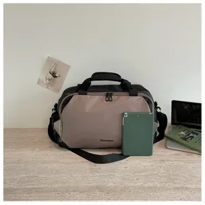 Color-blocked travel duffel bag detail showcasing dual handles, durable fabric and modern design.