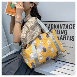 Cute bear print travel duffel bag detail showcasing yellow fabric and gray straps.