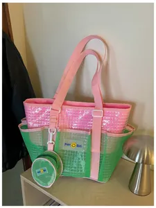 Pink and green mesh beach tote bag with small coin purse, stylish shoulder bag for travel.