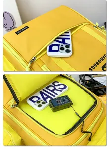 Detailed view of large capacity yellow travel backpack pocket with durable fabric.