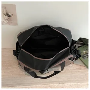 Detailed interior view of a stylish two-tone travel duffel bag with spacious compartments.