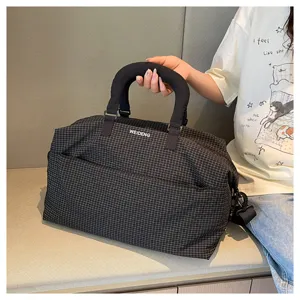 Black plaid travel duffel bag with handles, fashion shoulder bag for commute and gym.