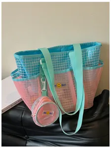 Detailed view of blue and pink mesh beach tote bag with cute round pouch and strap closeup