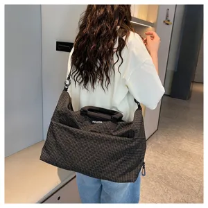Detailed view of fashion plaid travel duffel bag, casual shoulder bag for commuting and gym.