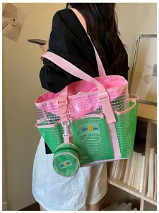 Detailed lifestyle view of a green pink mesh tote bag with a matching small coin purse.