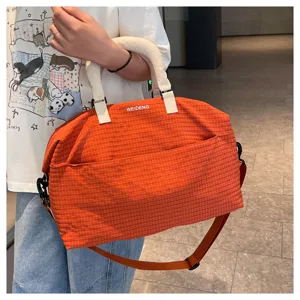 Orange plaid travel duffel bag with handles and shoulder strap for casual daily trips.