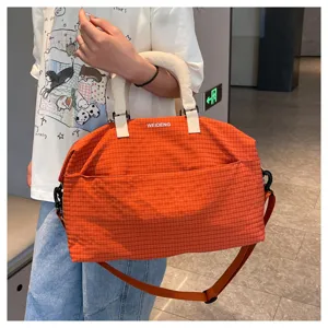 Orange plaid travel bag with strap, casual commuter luggage duffel for daily use and short trips.