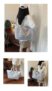 Large capacity grey travel duffel bag with expandable design and comfortable carry handles.