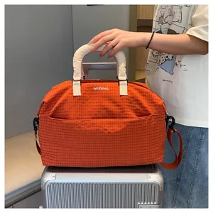 Orange plaid travel duffel bag with top handles and shoulder strap for gym and short trips.