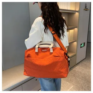 Orange plaid travel duffel bag, stylish commuter shoulder handbag with adjustable strap.