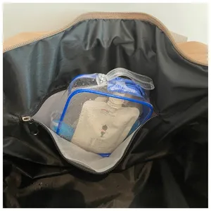 Large capacity travel bag interior detail shot showing spacious storage and clear toiletry pouch.