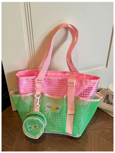 Detailed view of colorful mesh beach tote bag featuring pink straps and hanging round pouch.