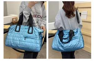 Detailed view of the shiny puffer travel duffel bag, casual quilted weekender bag with straps.