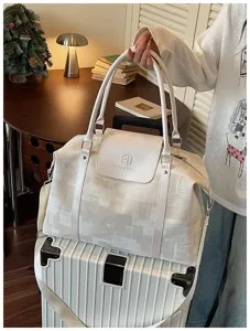 Canvas travel duffel bag for women, stylish weekend overnight bag with shoulder strap.