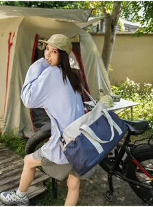 Color-blocked travel duffel bag with shoulder strap, stylish outdoor camping luggage storage.