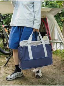 Outdoor camping scene detail showcasing large capacity travel duffel bag in dual tone.