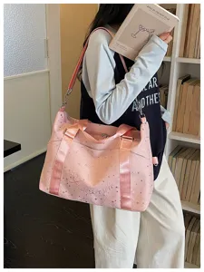 Stylish pink star print travel duffel bag with shoulder strap for gym and commuting.