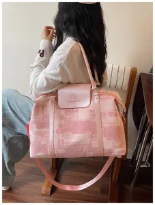Pink oil painting travel bag detail showing shoulder carry and large capacity design.