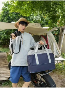 Color-blocked travel duffel bag, outdoor camping luggage bag, large capacity, durable canvas.