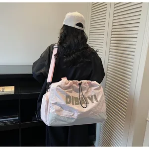 Large capacity pink travel duffel bag with drawstring closure and shoulder strap detail.
