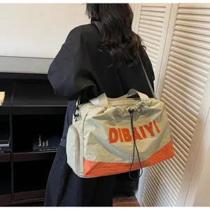 Casual travel duffel bag with color block design, strap and spacious interior for commute.