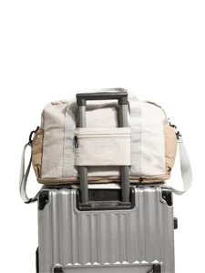 Color-block travel duffel bag with luggage sleeve, durable canvas shoulder bag for trip.