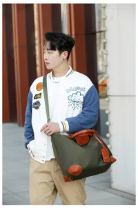 Large capacity travel duffel bag with durable nylon body and stylish brown leather accents.
