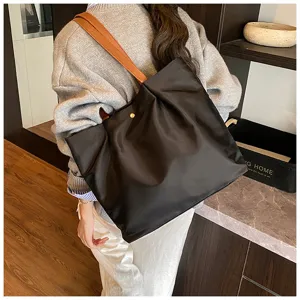 Solid color casual single-shoulder tote bag, minimalist commute daily handbag with brown strap.