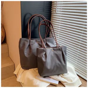 Minimalist solid color tote bag set with brown handles, perfect for daily commuting and travel.