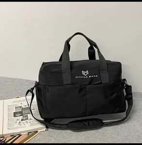 Black travel duffel bag for fitness and sports, durable crossbody shoulder bag for daily commuting.