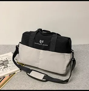 Stylish black and white travel duffel bag with shoulder strap for outdoor fitness trips.