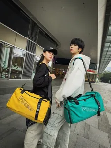 Stylish large capacity travel duffel bag sports fitness gym bag showcased by models outdoors
