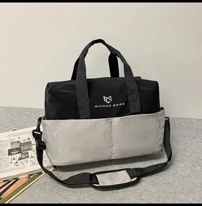 Water-resistant travel duffel bag with shoulder strap, ideal for outdoor fitness and sports.