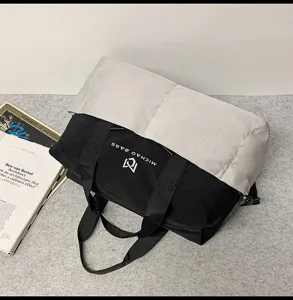 Detailed view of black and grey colorblock travel duffel bag with handles and logo.