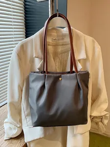 Solid color simple shoulder tote bag with brown handles for casual commuter daily travel.