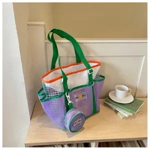 Stylish purple mesh beach tote bag with green straps for women travel fitness and swimming use.